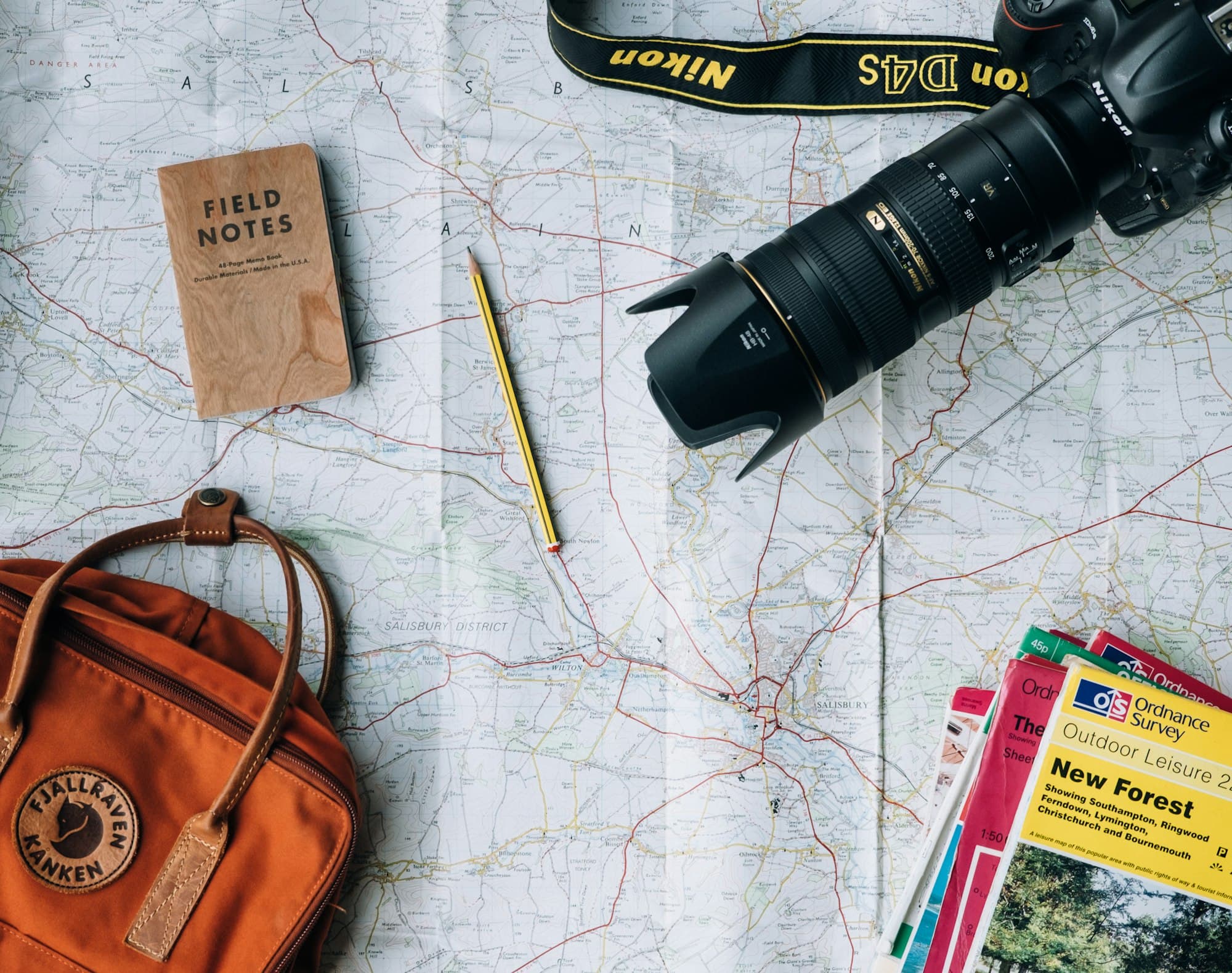 Planning a trip with maps and a laptop